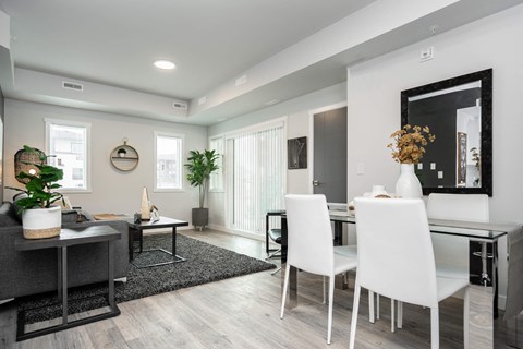 a dining room and living room with a table and chairs